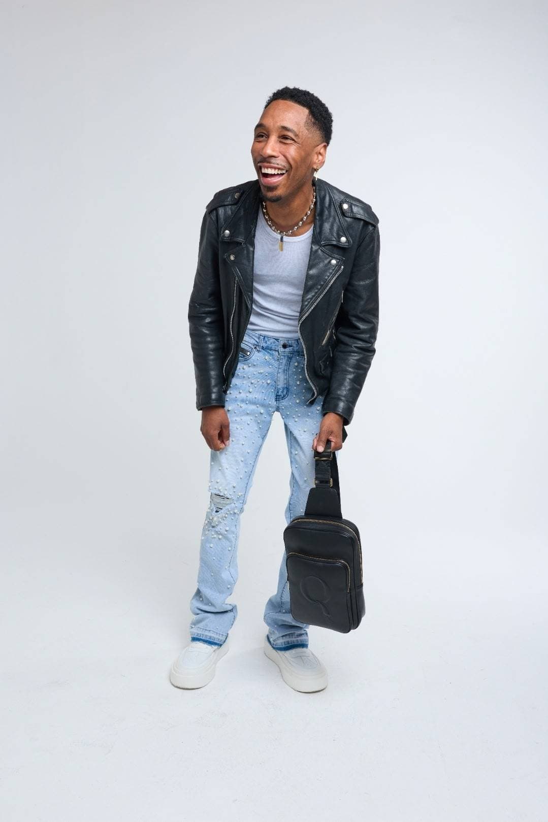 Model laughing while holding the Statement Sling